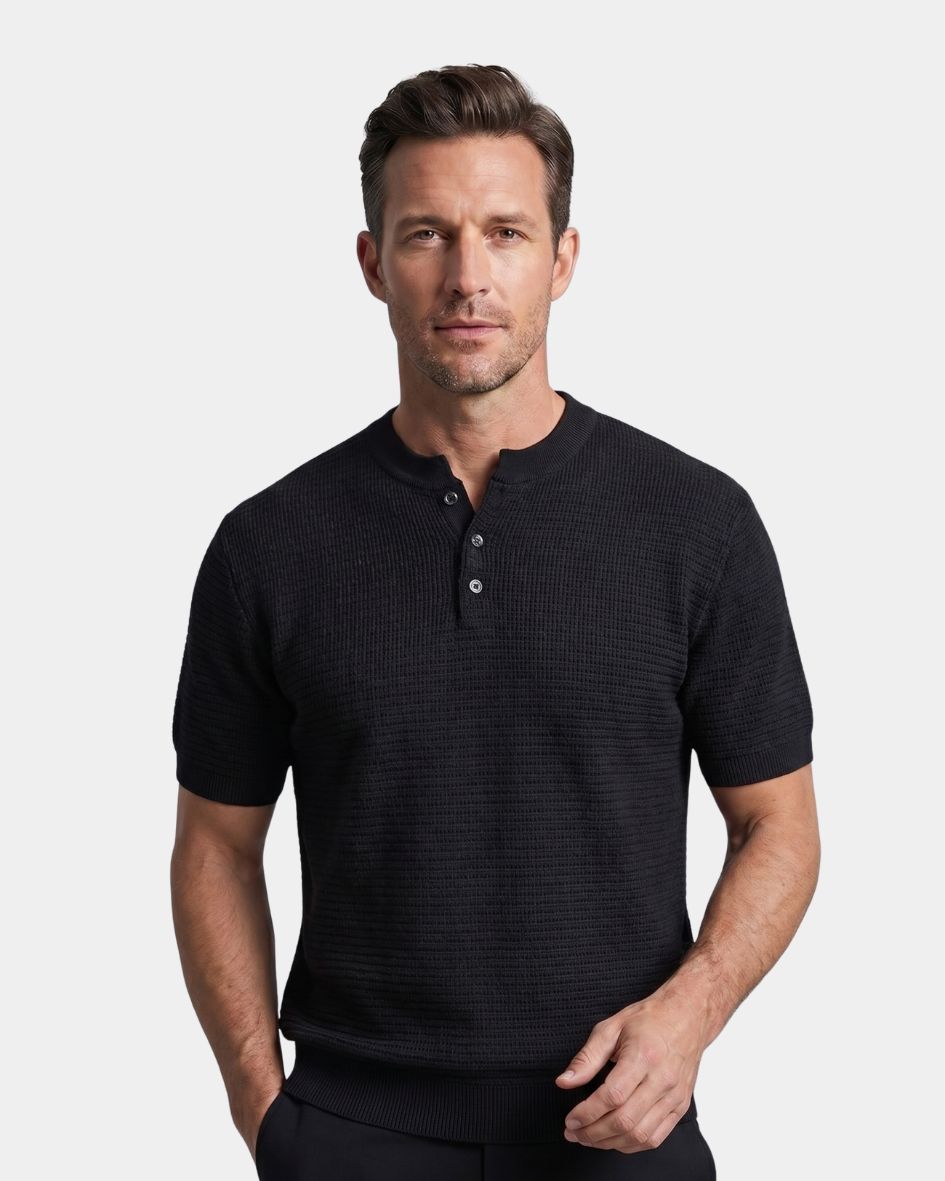 Man wearing a black short-sleeve henley shirt against a light gray background