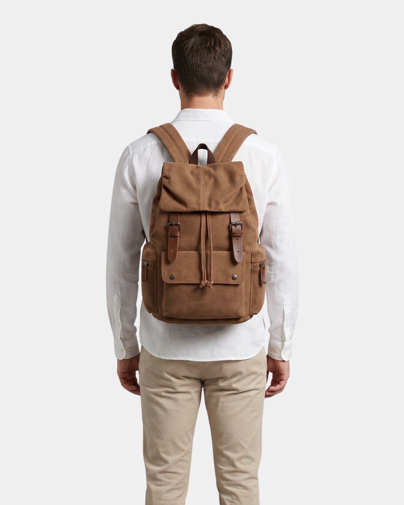 Ashton Vintage Canvas Backpack in brown with buckle straps worn on model