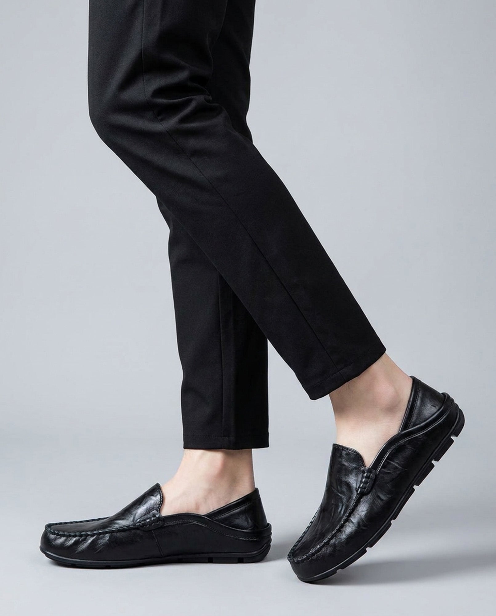 Beckett men's black leather driving loafers styled while walking