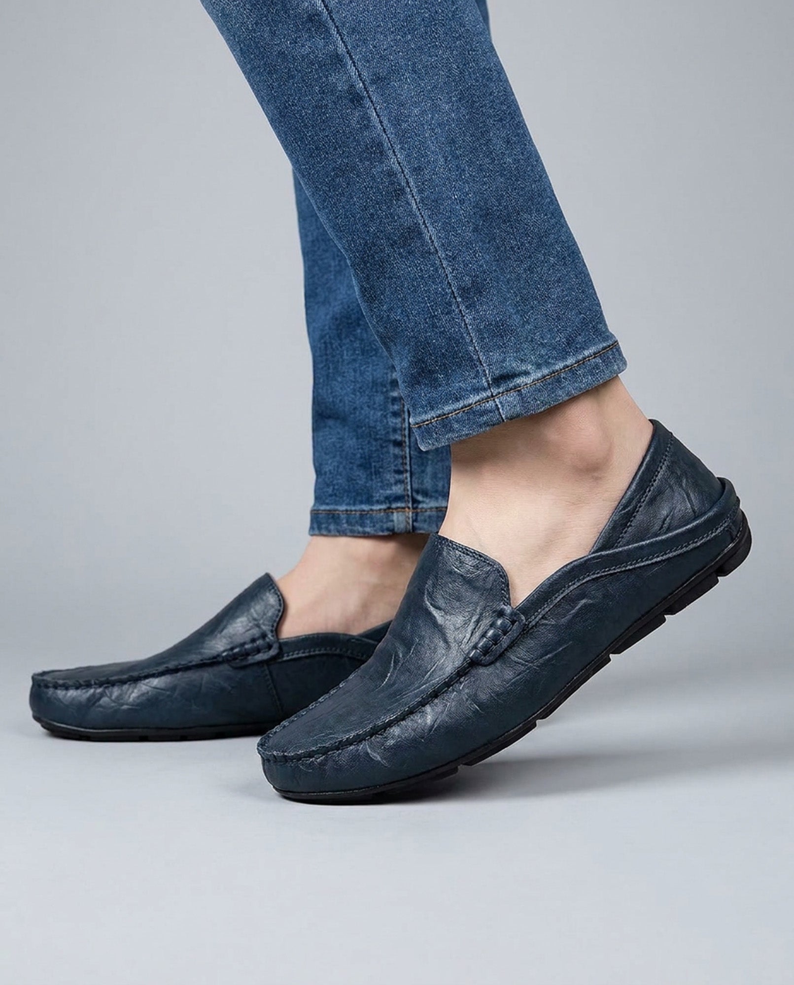 Beckett men's navy leather driving loafers styled while walking