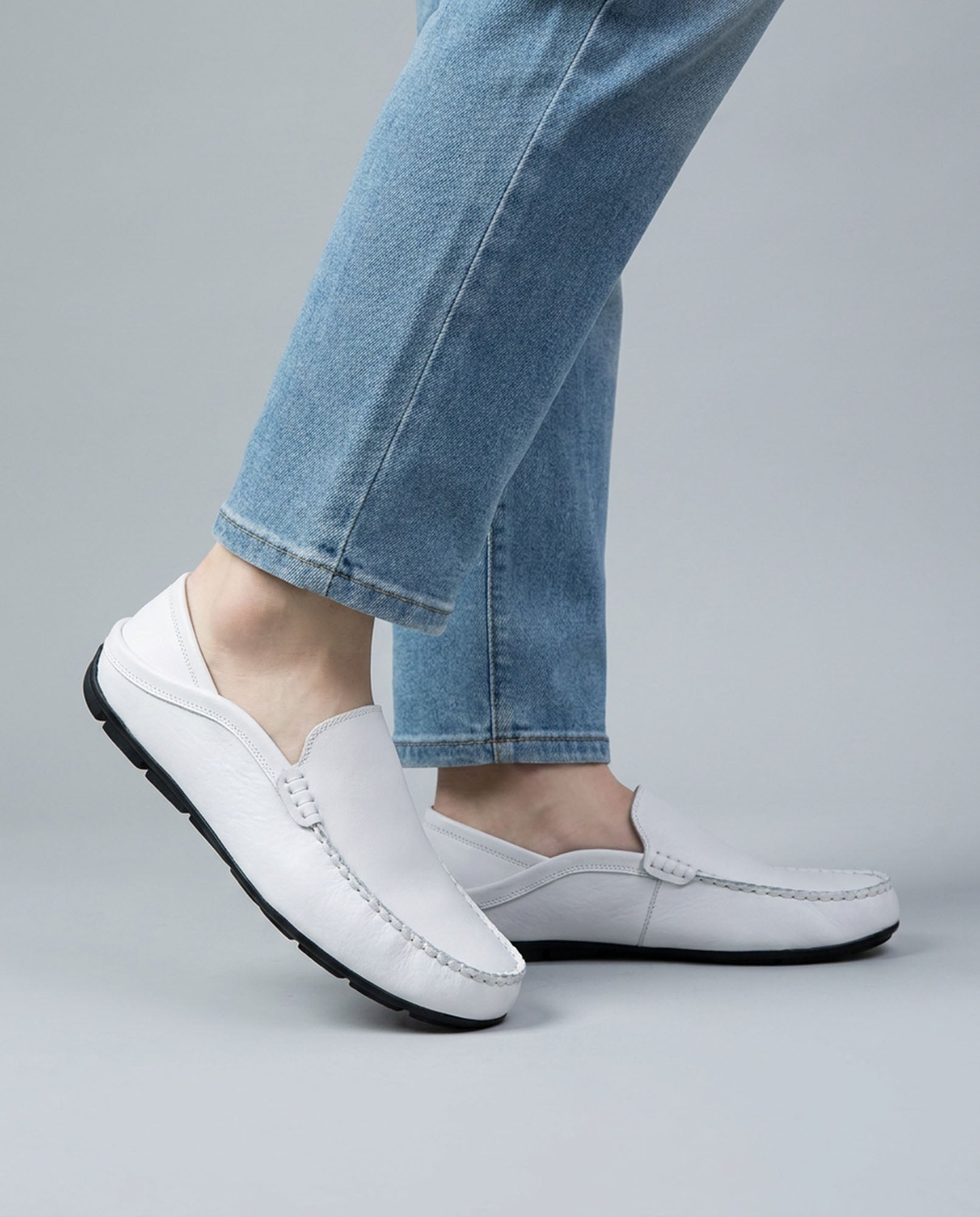 Beckett men's white leather driving loafers worn with blue denim jeans