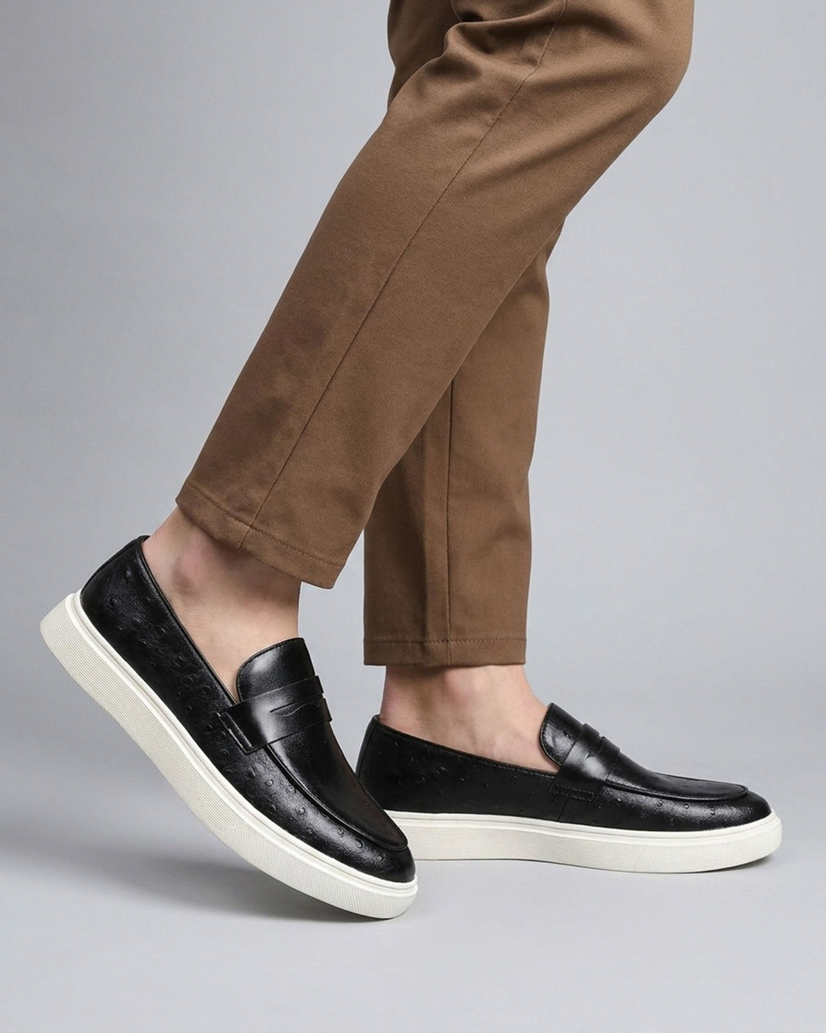 Belmont men's black penny loafer sneakers styled with tan chino trousers