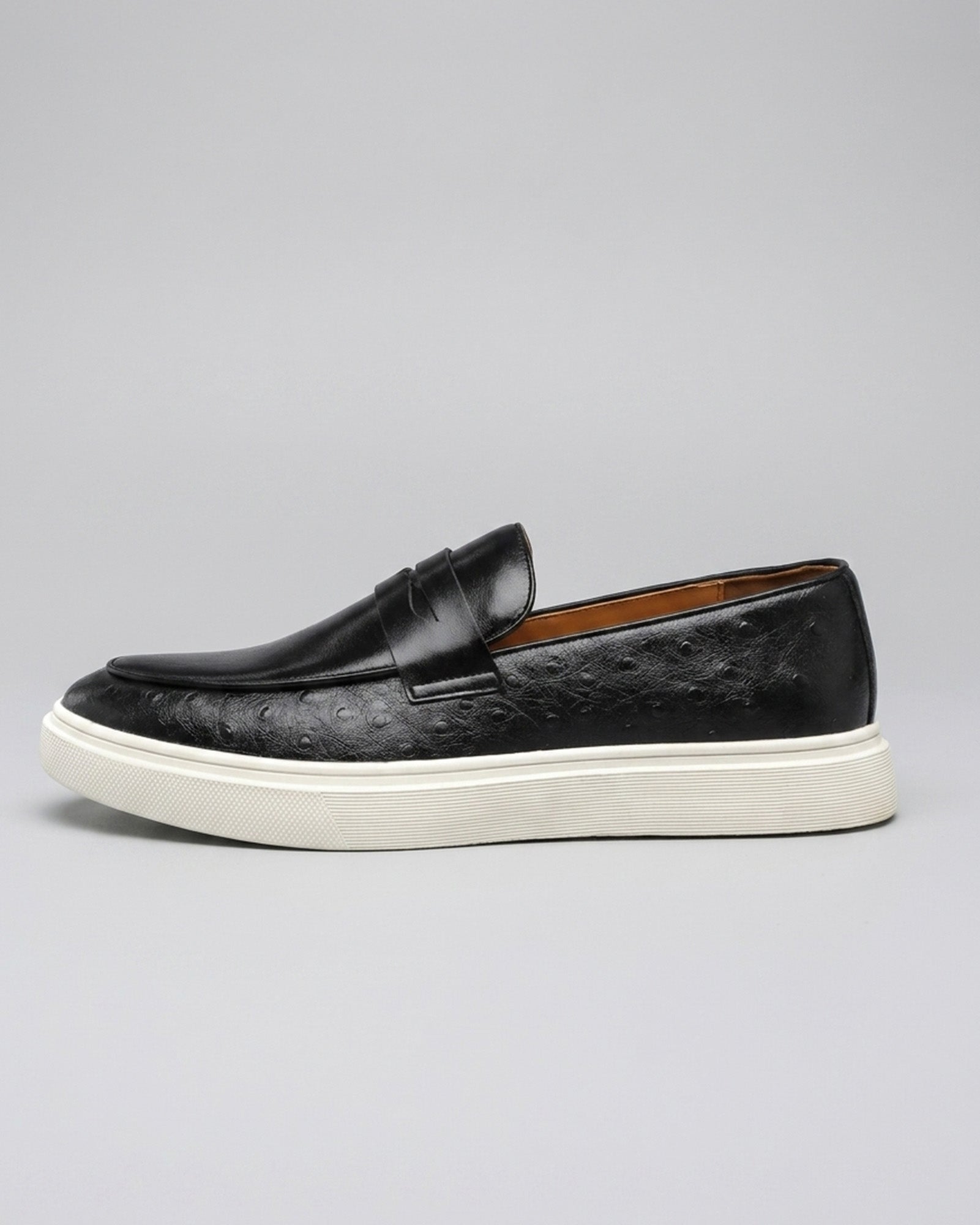 Side view of Belmont men's black penny loafer sneaker with off-white cupsole