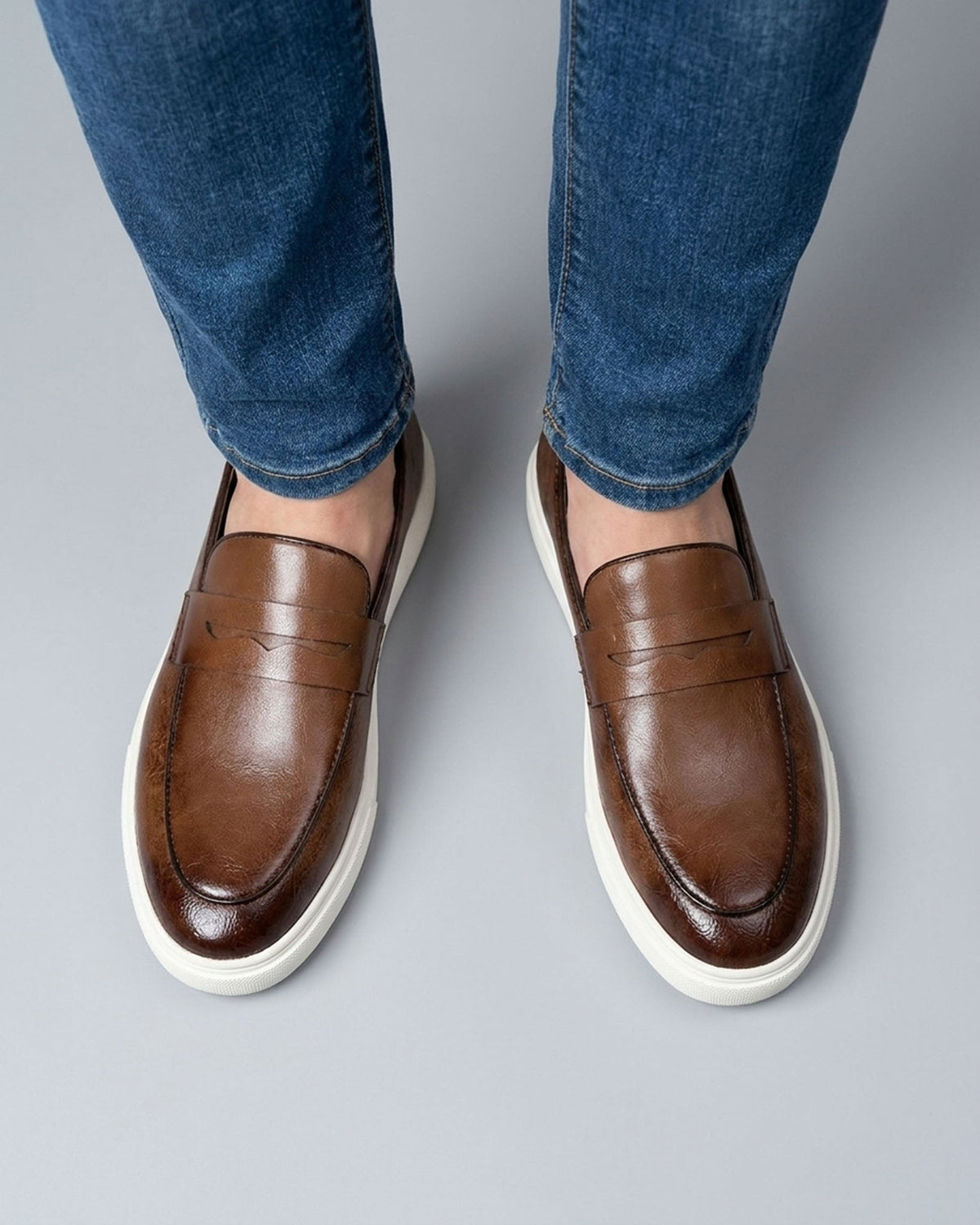 Overhead view of Belmont men's brown penny loafer sneakers with classic penny strap and off-white cupsole