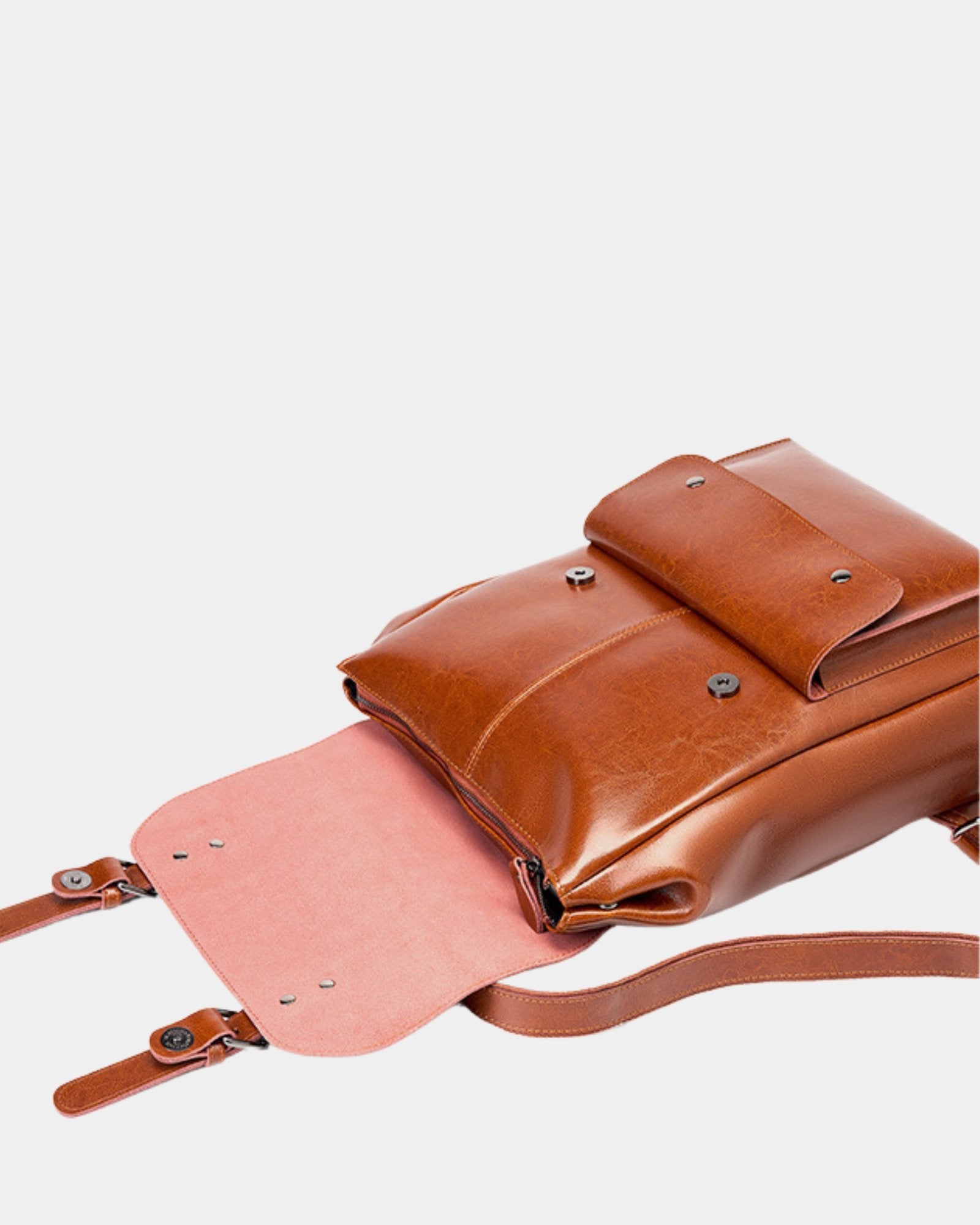 Cambridge brown leather backpack with front flap pocket open showing magnetic snap closure