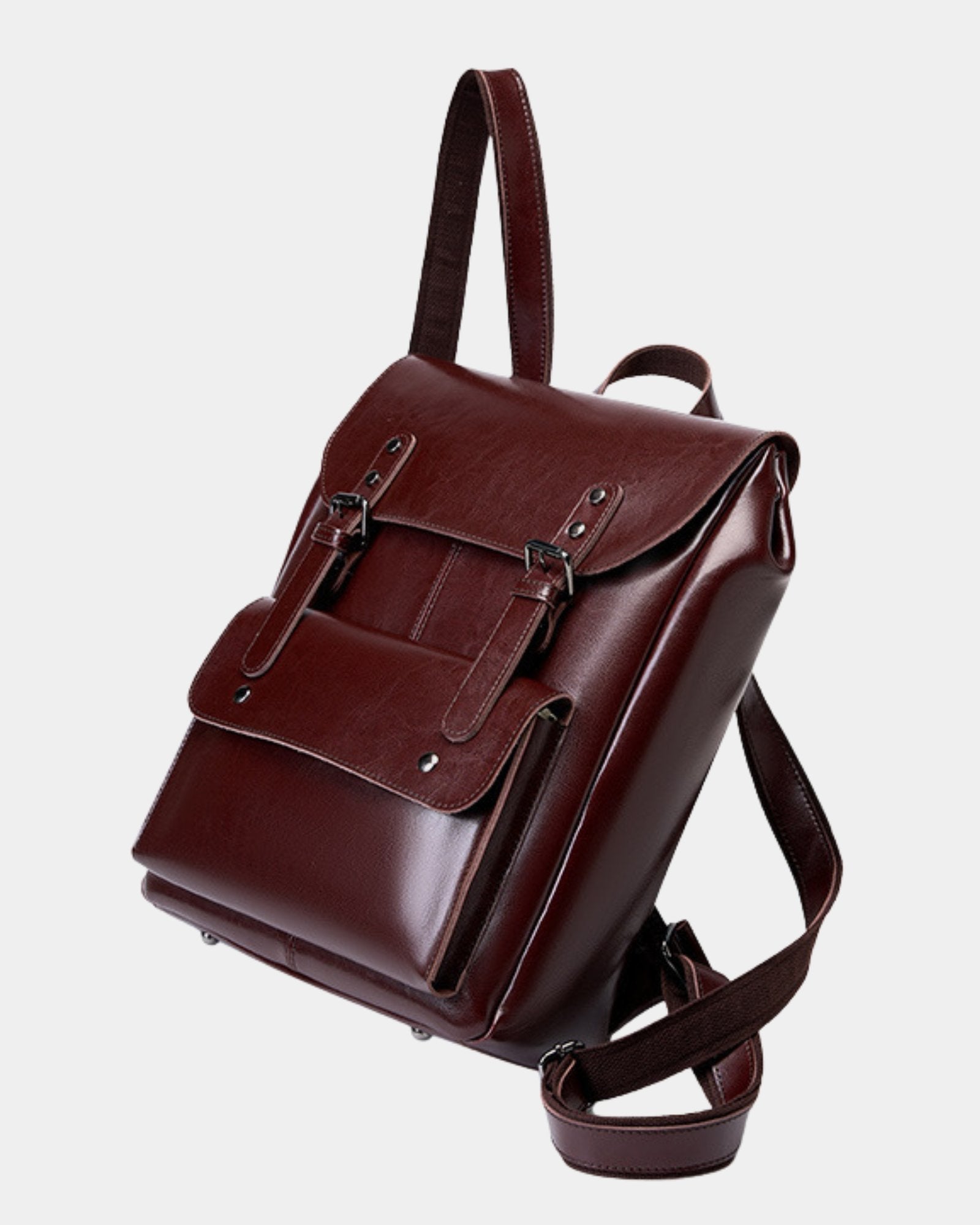 Three-quarter view of Cambridge burgundy leather backpack showing flap closure and strap detail