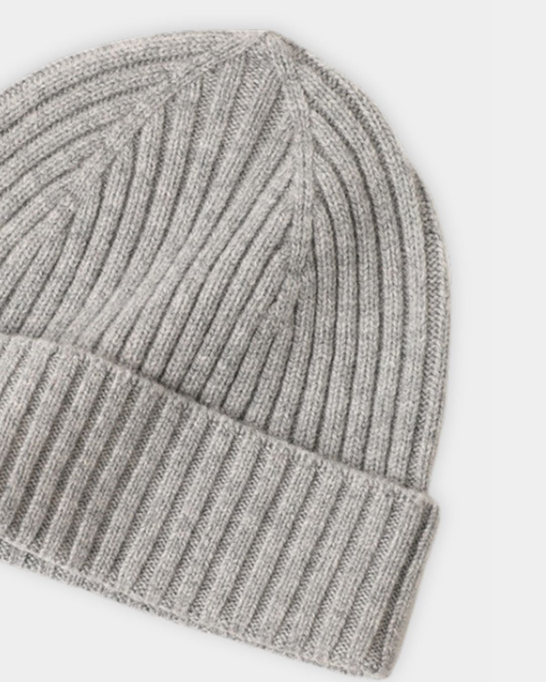 Light gray cashmere beanie with a classic ribbed knit texture and a folded cuff for a warm winter look.
