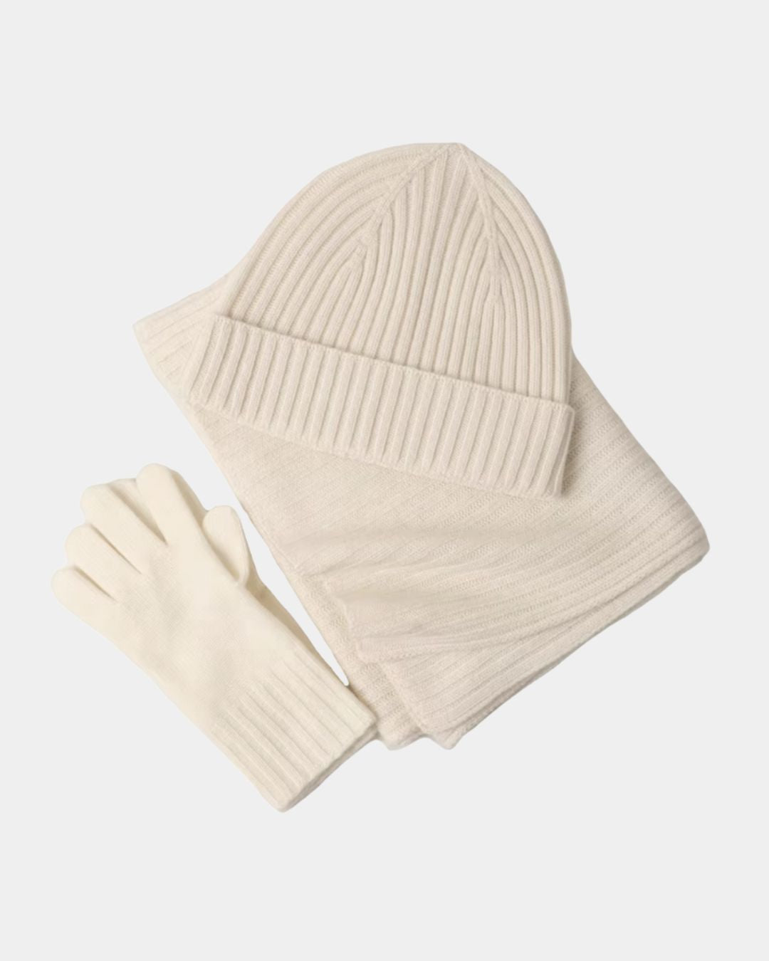 Cream cashmere winter set featuring a ribbed beanie, long scarf, and matching knit gloves.