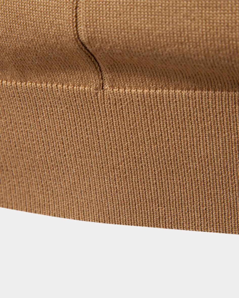 Close-up of camel fabric texture on a white background