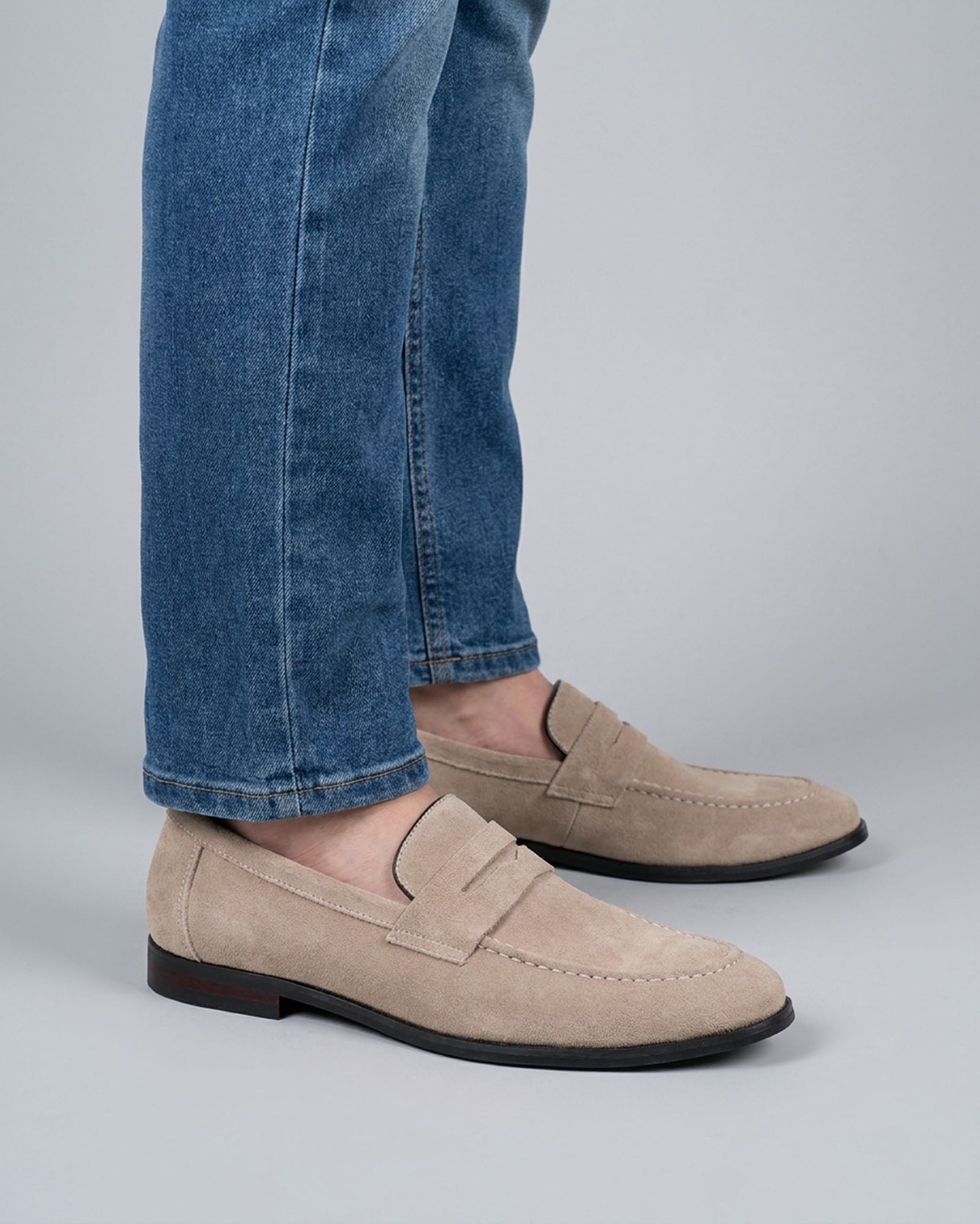 Harper men's beige suede penny loafers styled with blue denim jeans