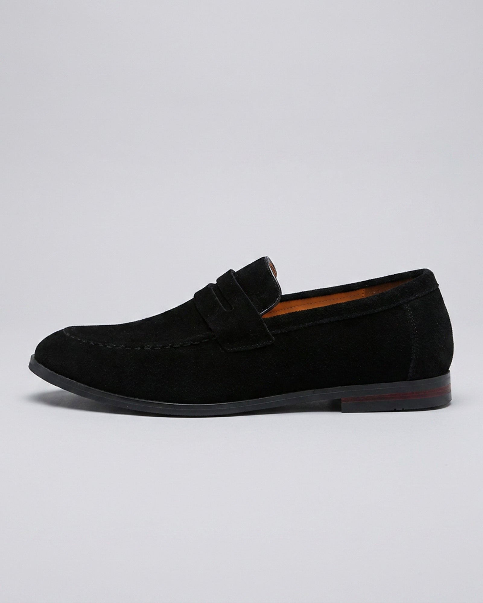Side view of Harper men's black suede penny loafers on grey background