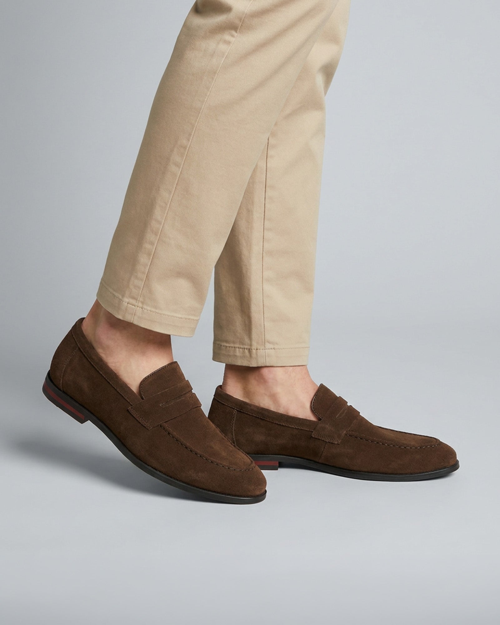 Harper men's dark brown suede penny loafers styled with beige chino trousers