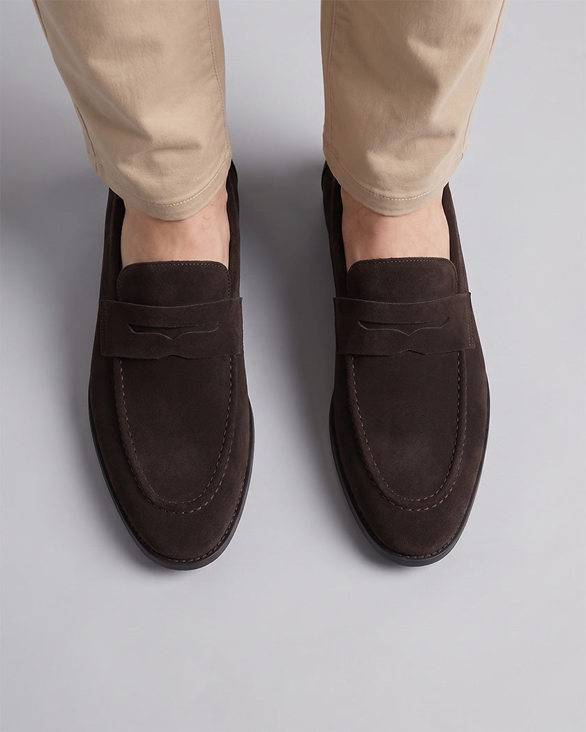 Overhead view of Harper men's dark brown suede penny loafers with penny strap detail styled with beige chino trousers