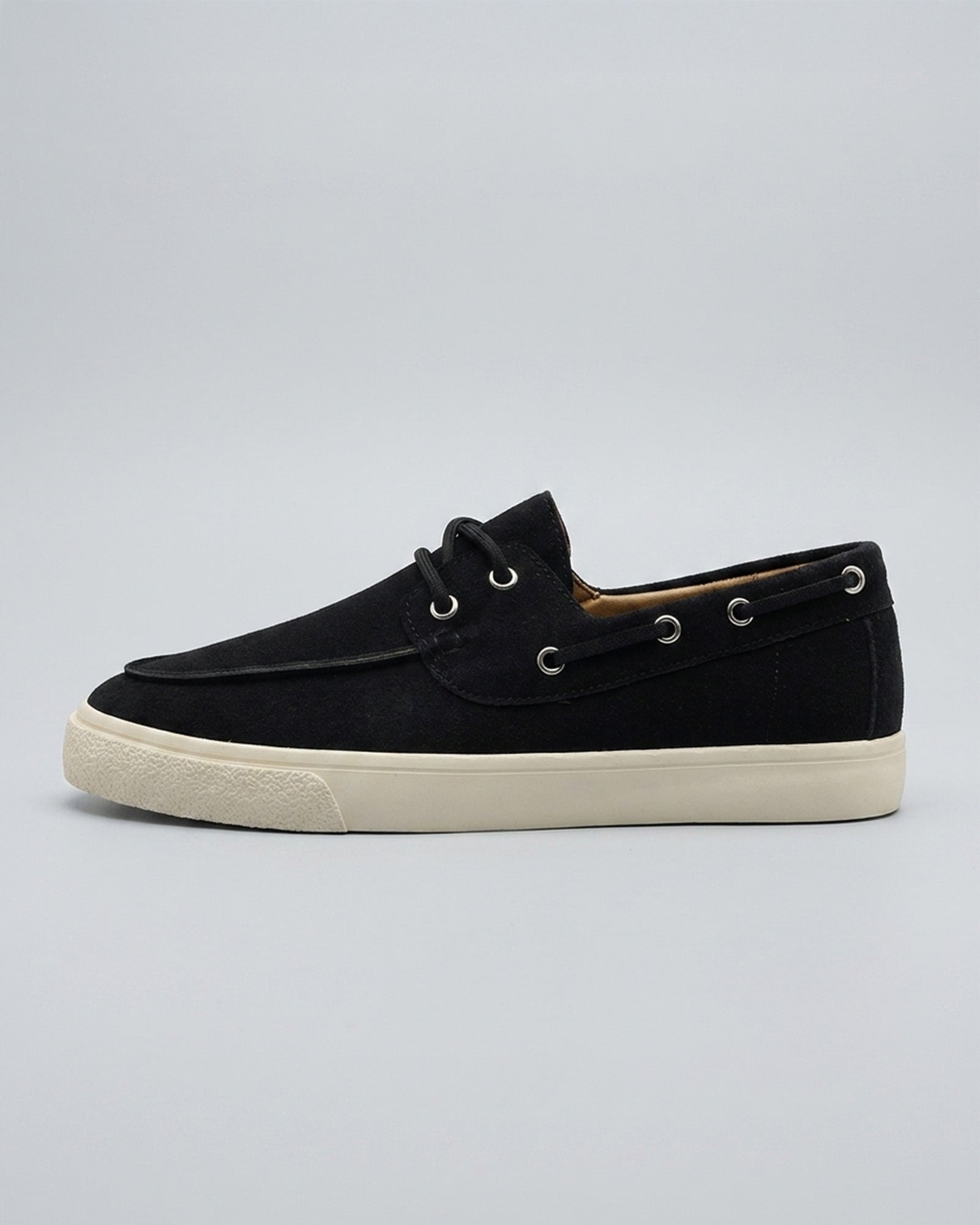 Side view of Harwich men's suede boat shoe sneaker in black with cream cupsole