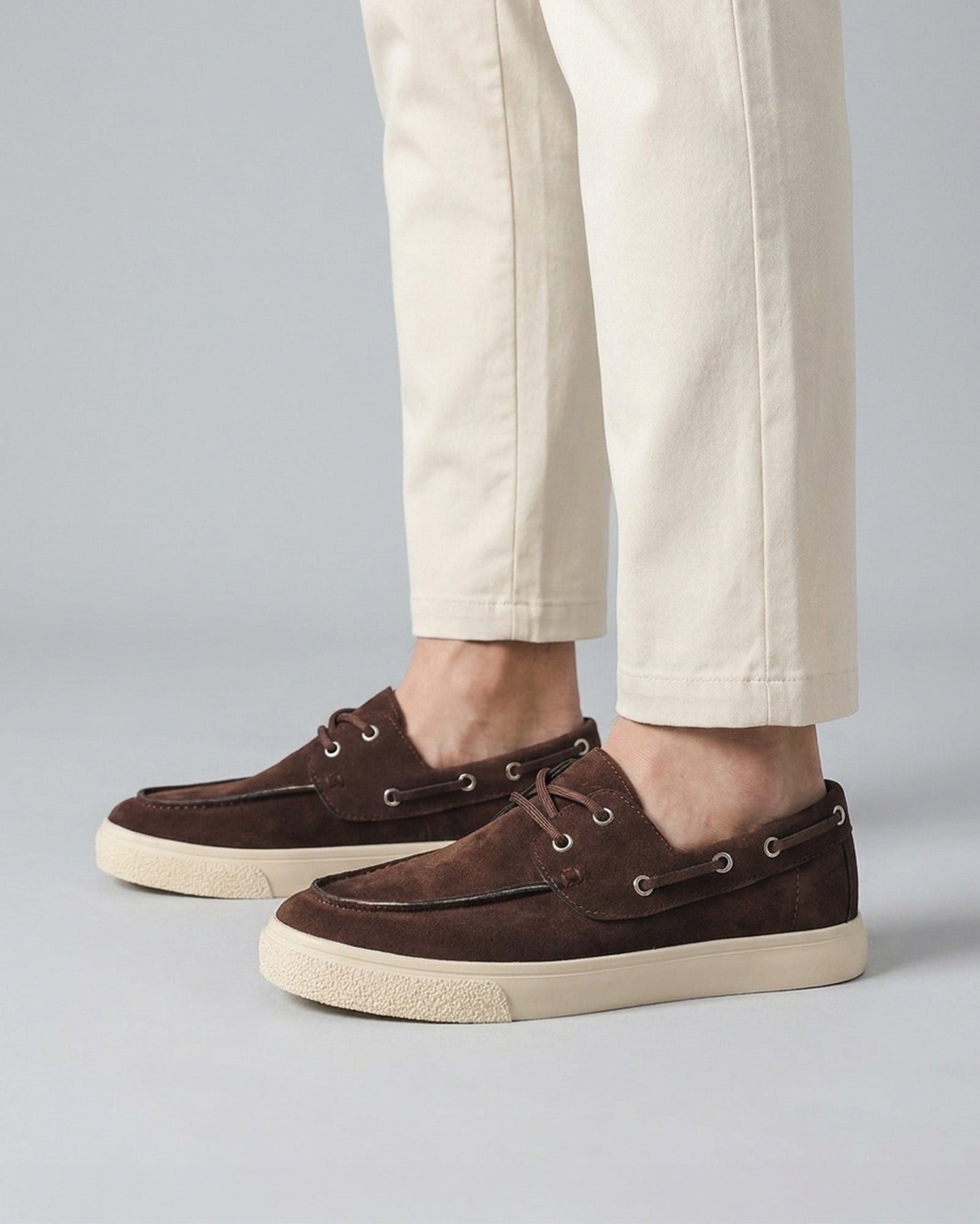 Lifestyle view of Harwich men's suede boat shoe sneakers in brown with cream cupsole