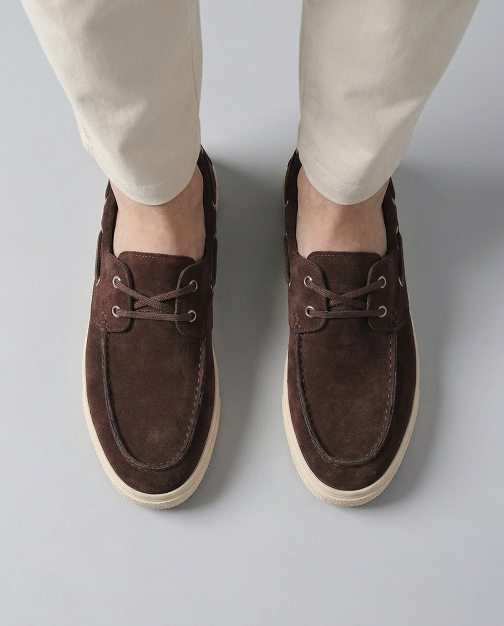Overhead view of Harwich men's suede boat shoe sneakers in brown with moccasin stitching