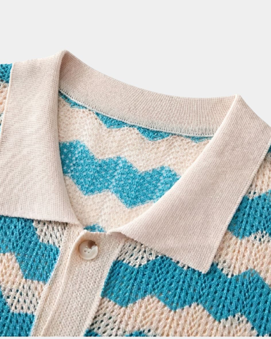 Close-up of a knitted cardigan with blue and beige pattern on a light background