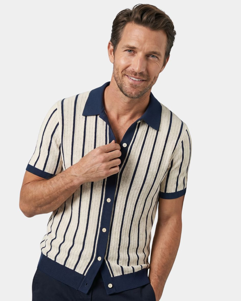 Man wearing a striped shirt with navy accents on a white background