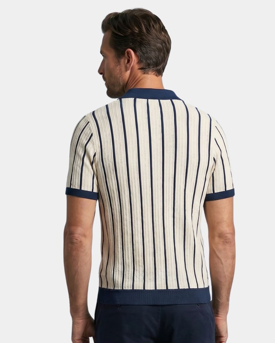 Man wearing a striped polo shirt with navy accents on a light gray background