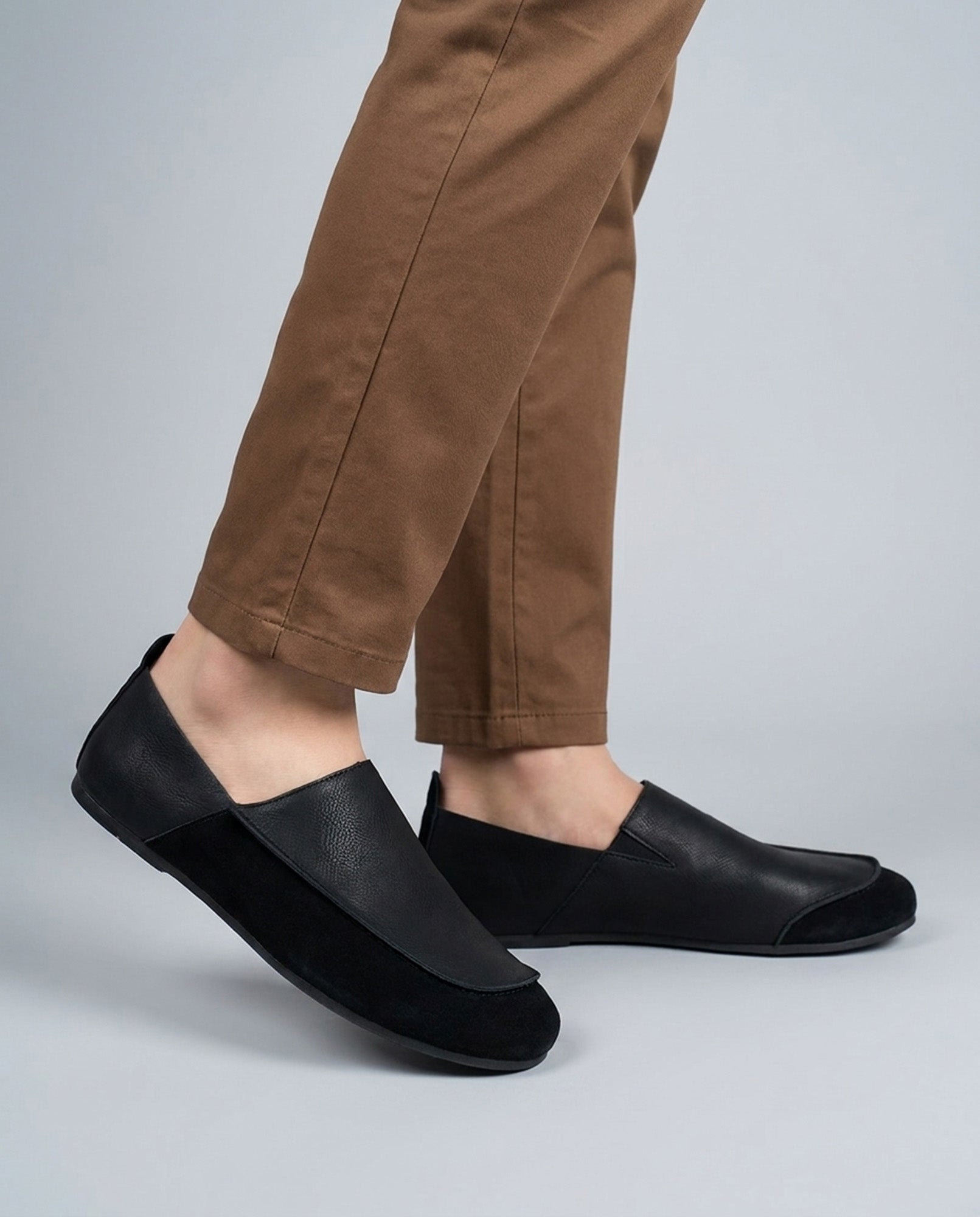 Luca men's black relaxed slip-on loafers worn with brown trousers