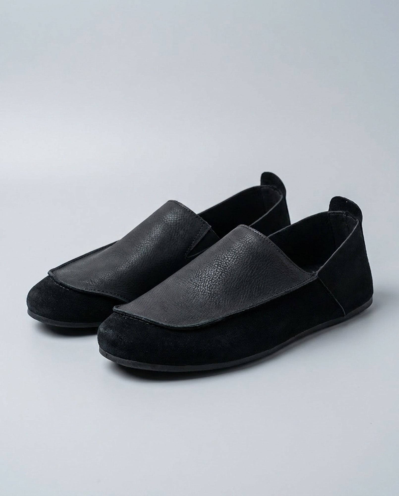 Pair of Luca men's black relaxed slip-on loafers with contrast vamp panel