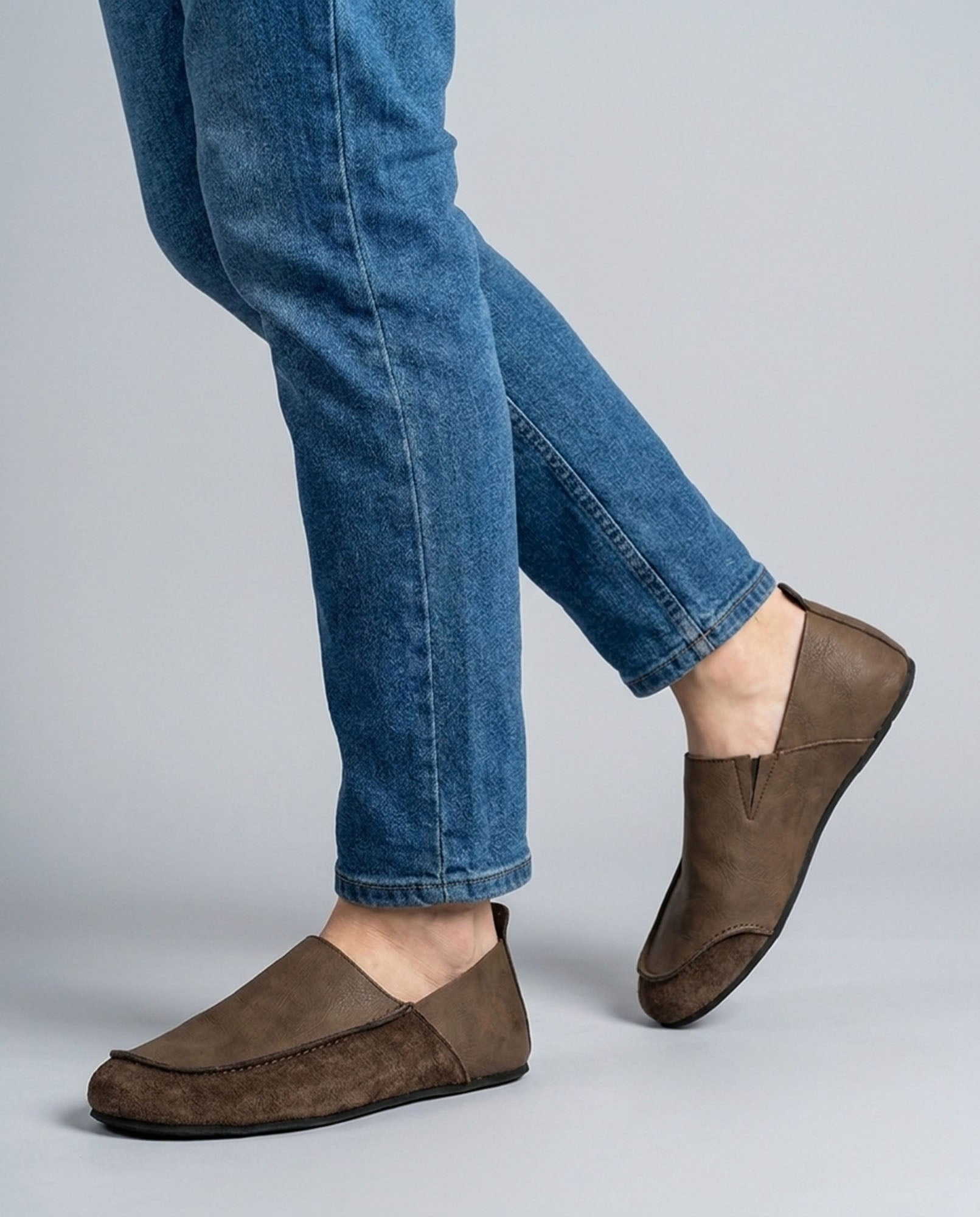 Luca men's brown relaxed slip-on loafers mid-stride styled with blue denim jeans