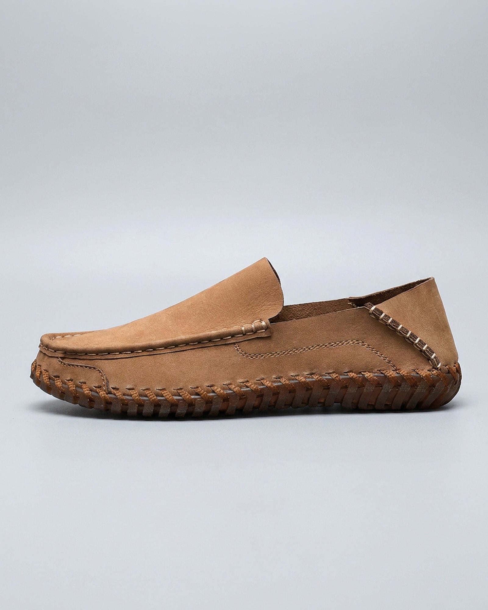 Side view of Marlow men's tan leather driving loafer with woven sole detailing