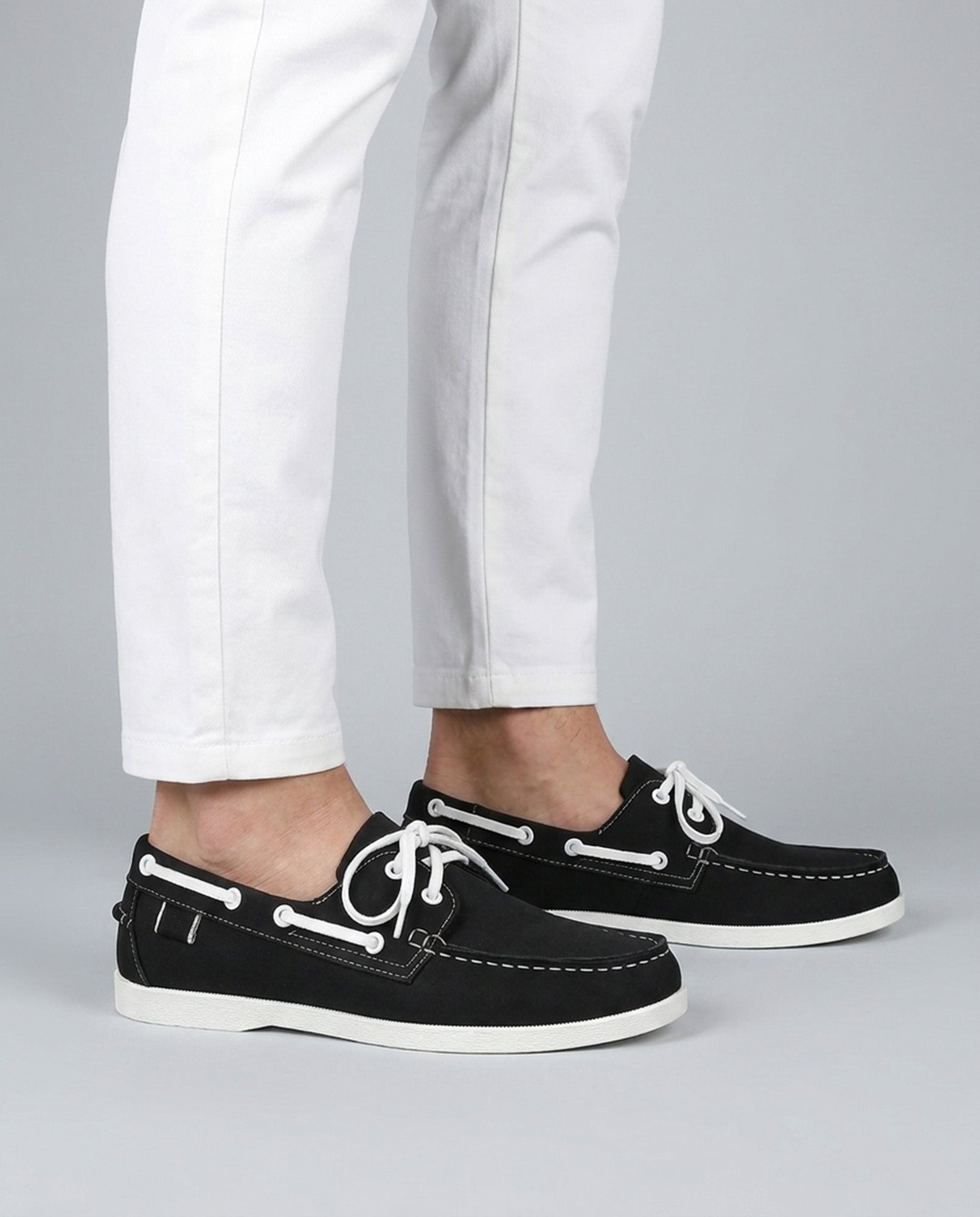 Nightdock men's black boat shoes styled with white trousers