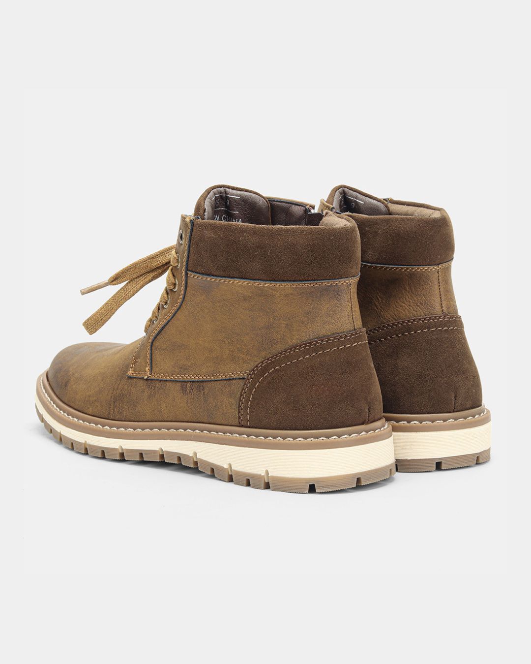 Men’s brown lace-up ankle boots featuring a padded collar, side zipper, and a contrast white rubber lug sole.