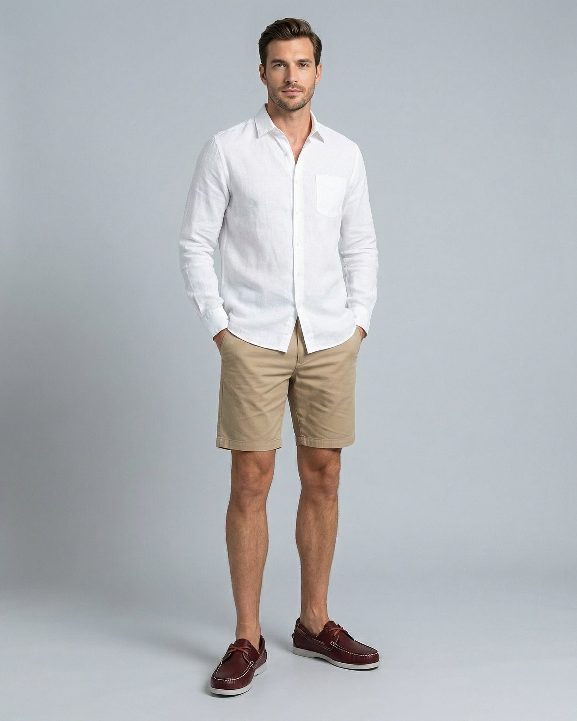 Men's burgundy faux leather boat shoes with white rubber sole styled with chino shorts – full length