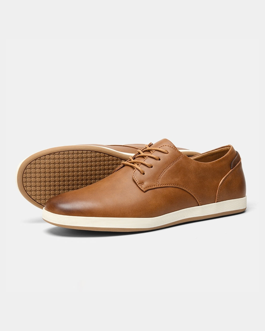 Tan synthetic leather lace-up dress sneakers with a white midsole and a textured rubber outsole.