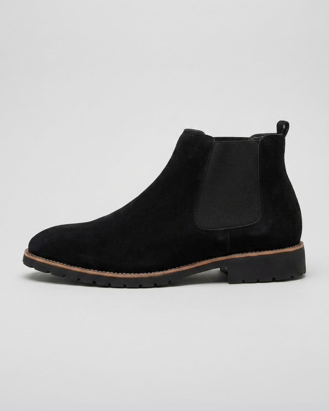 Men’s black suede Chelsea boots with elastic side panels, a rounded toe, and a durable lugged rubber outsole.