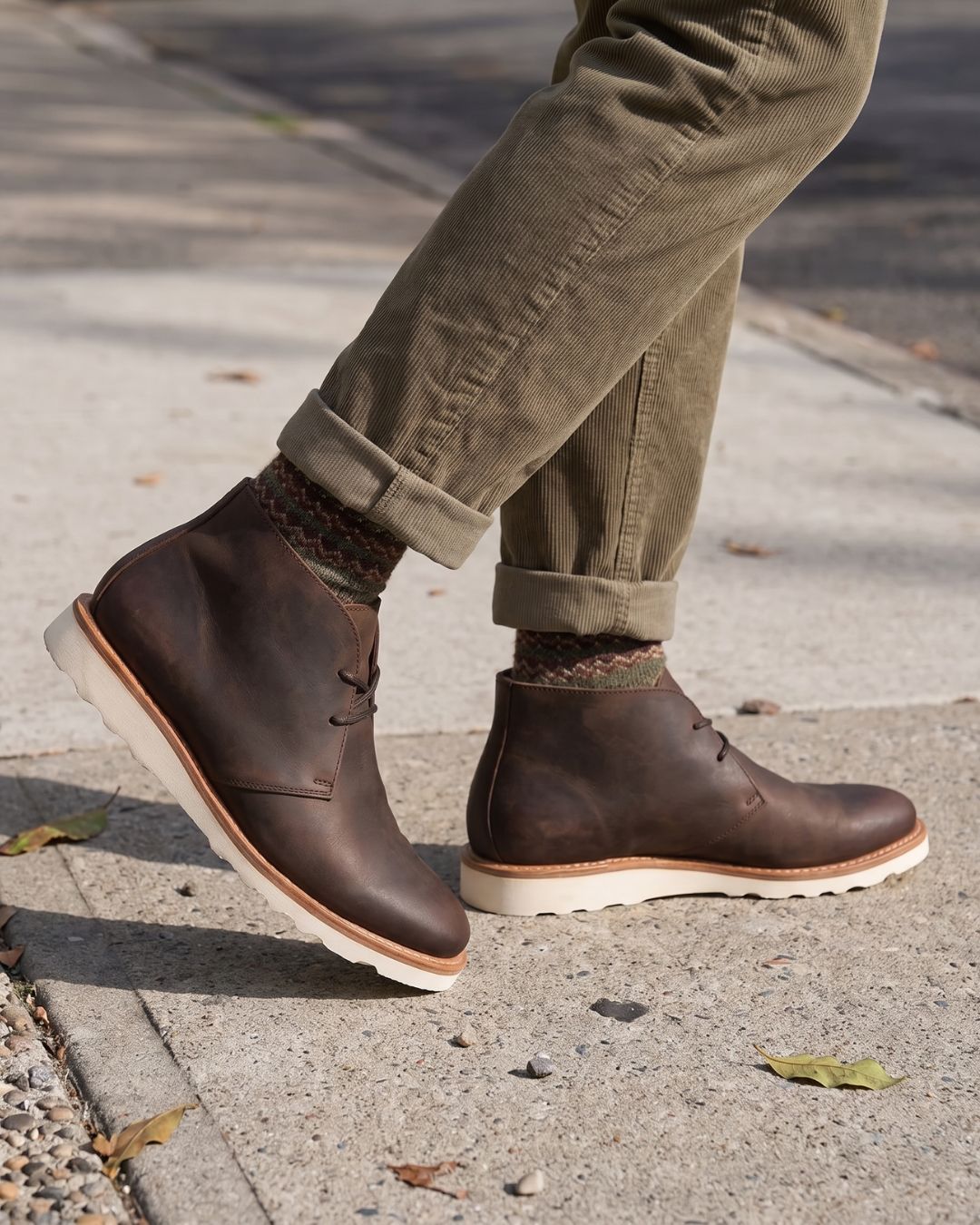 Men’s brown faux leather chukka boots featuring a chunky white foam sneaker sole and lace-up ankle design.