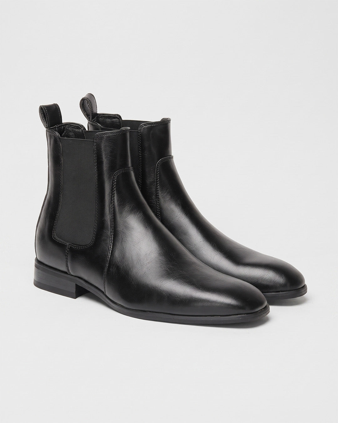 Men’s black Chelsea dress boots with a smooth finish, square toe, elastic side panels, and a low-profile heel.