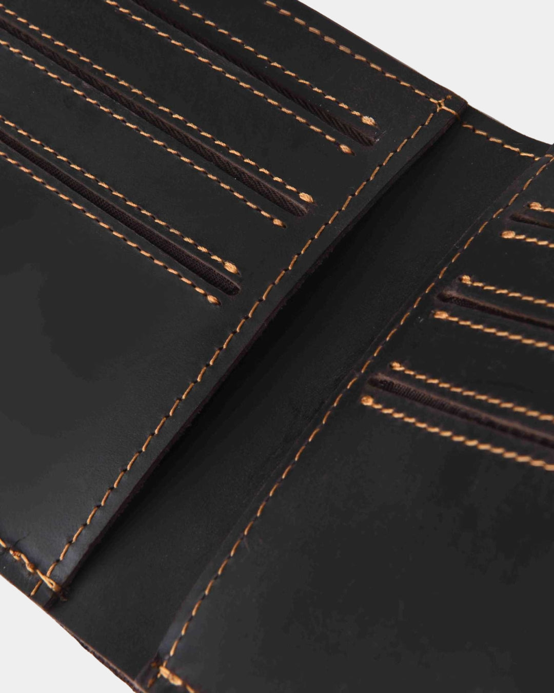 Dark brown Crazy Horse leather bifold wallet with six card slots and contrast stitching.