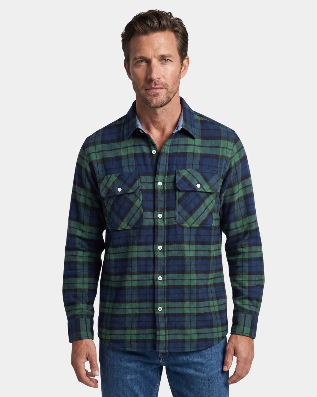 Man wearing a green and navy blue plaid flannel shirt with a button-front, two chest pockets, and a relaxed fit.