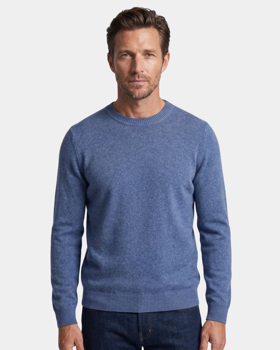 Man wearing a blue 100% wool crew neck sweater with ribbed trim and a clean, regular fit against a white background.
