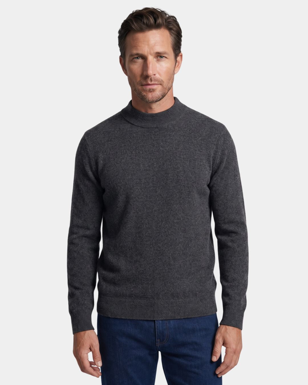 Man wearing a charcoal grey 100% wool mock neck sweater with ribbed cuffs and a clean hem.