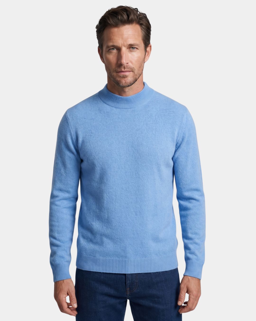 Man wearing a light blue 100% wool mock neck sweater with ribbed cuffs and a clean hem.