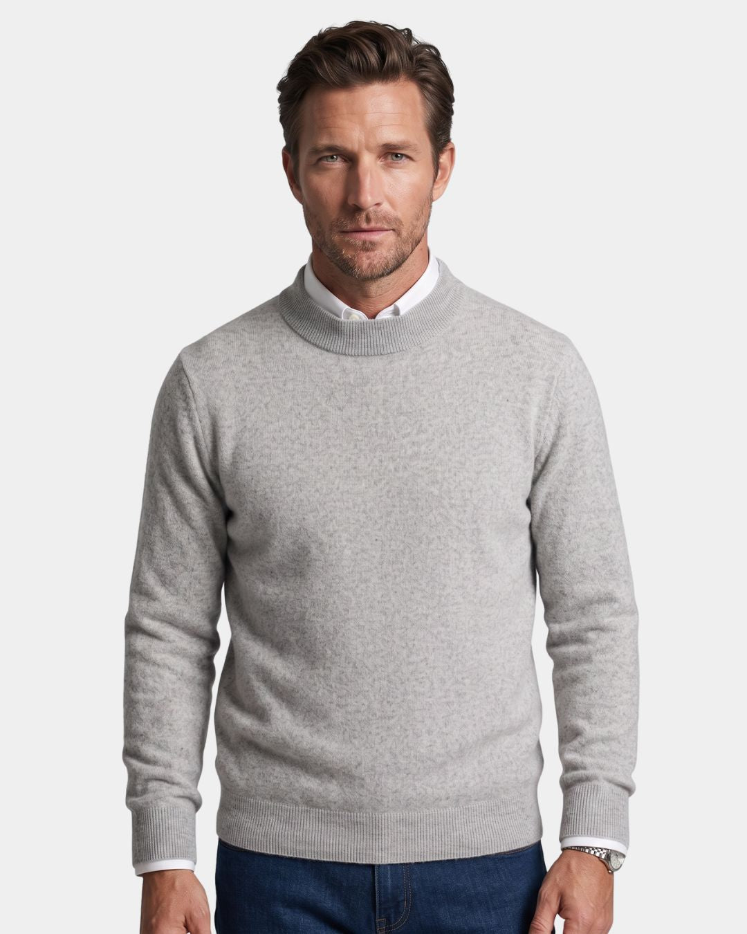 Man wearing a light grey 100% wool mock neck sweater with ribbed cuffs over a white collared shirt.