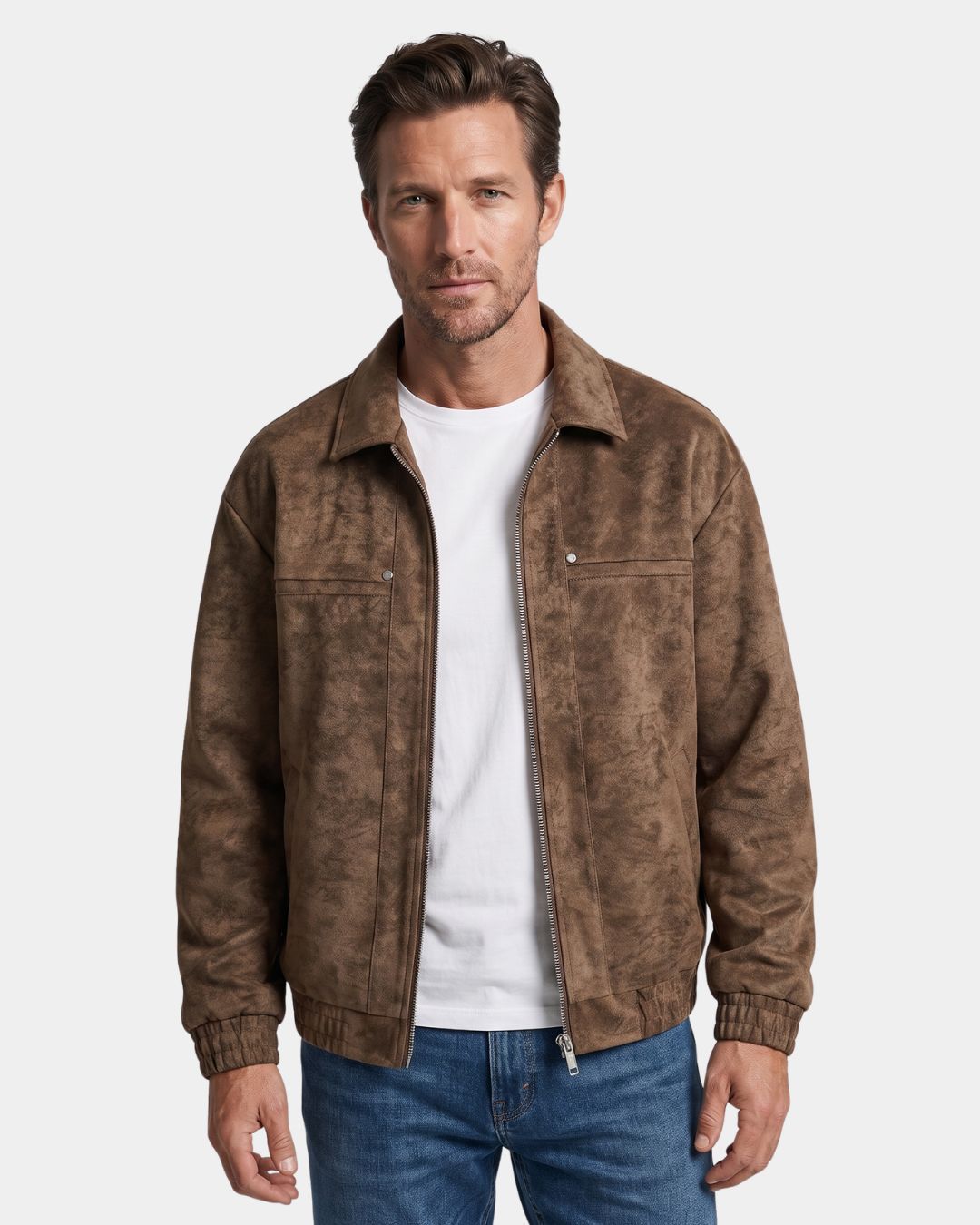 Man wearing a brown collared bomber jacket with white T-shirt and blue jeans