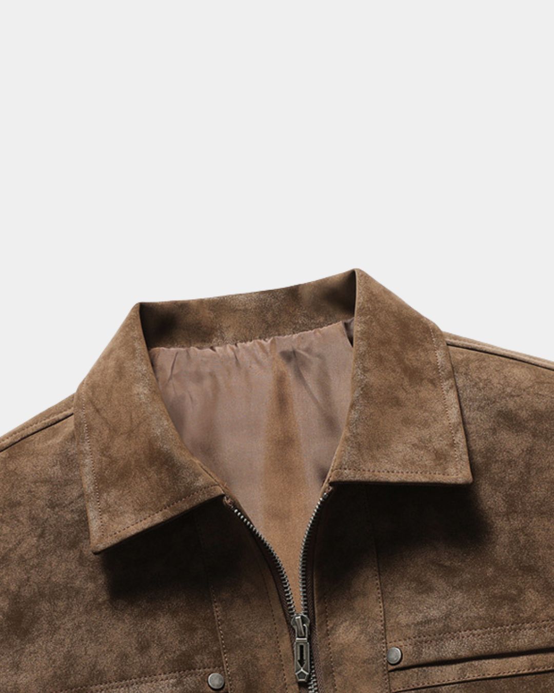 Close-up of a brown suede jacket collar with a silver zipper and metal snap buttons, set against a plain light gray background.