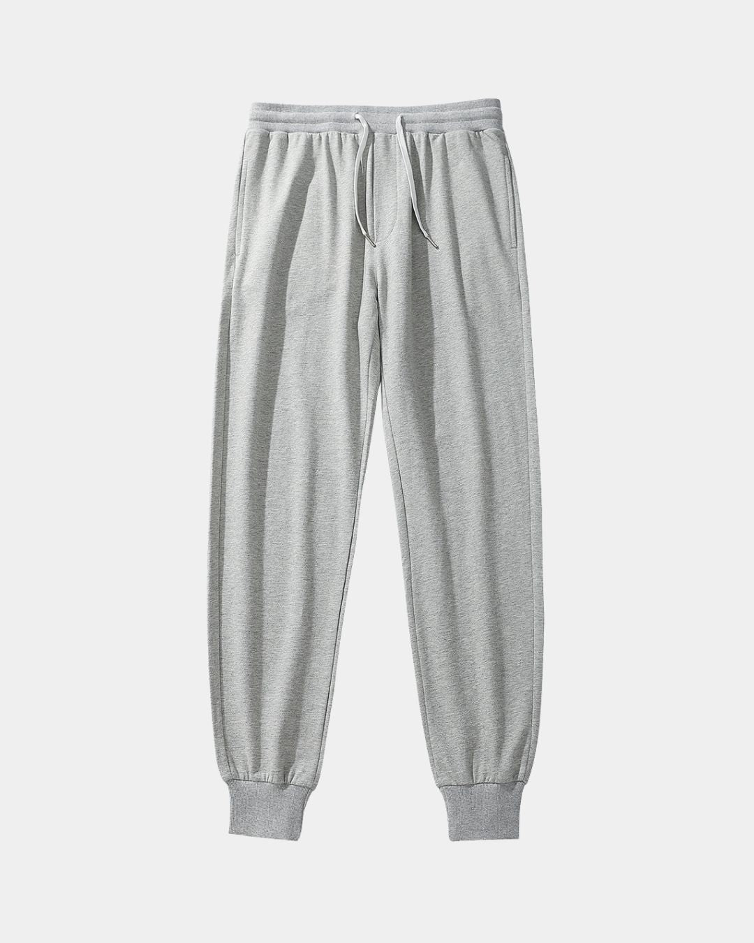 Men’s grey cotton jogger sweatpants with a drawstring waist and ribbed tapered ankle cuffs.