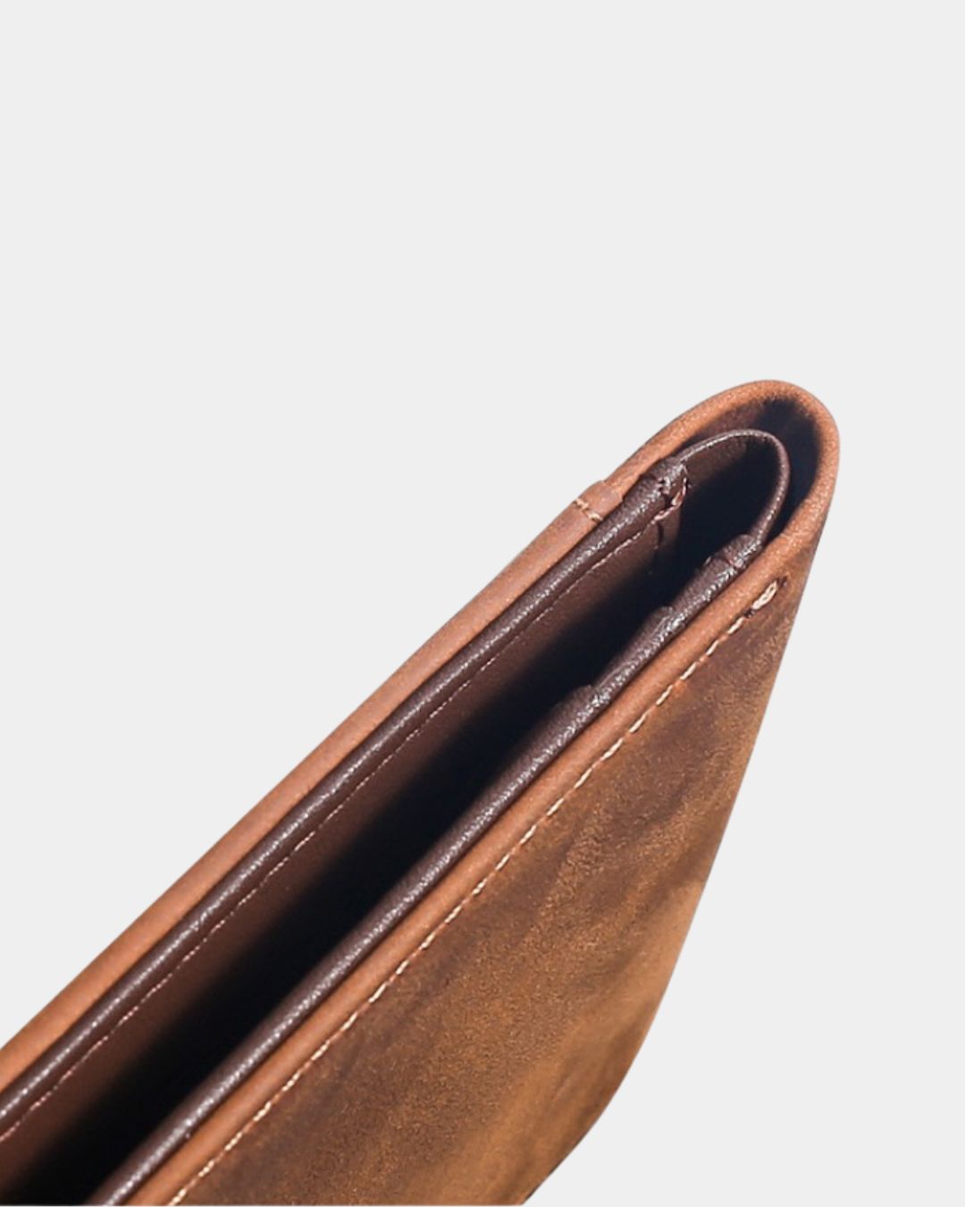 Slim brown Crazy Horse leather bifold wallet with a textured finish and reinforced stitched edges.