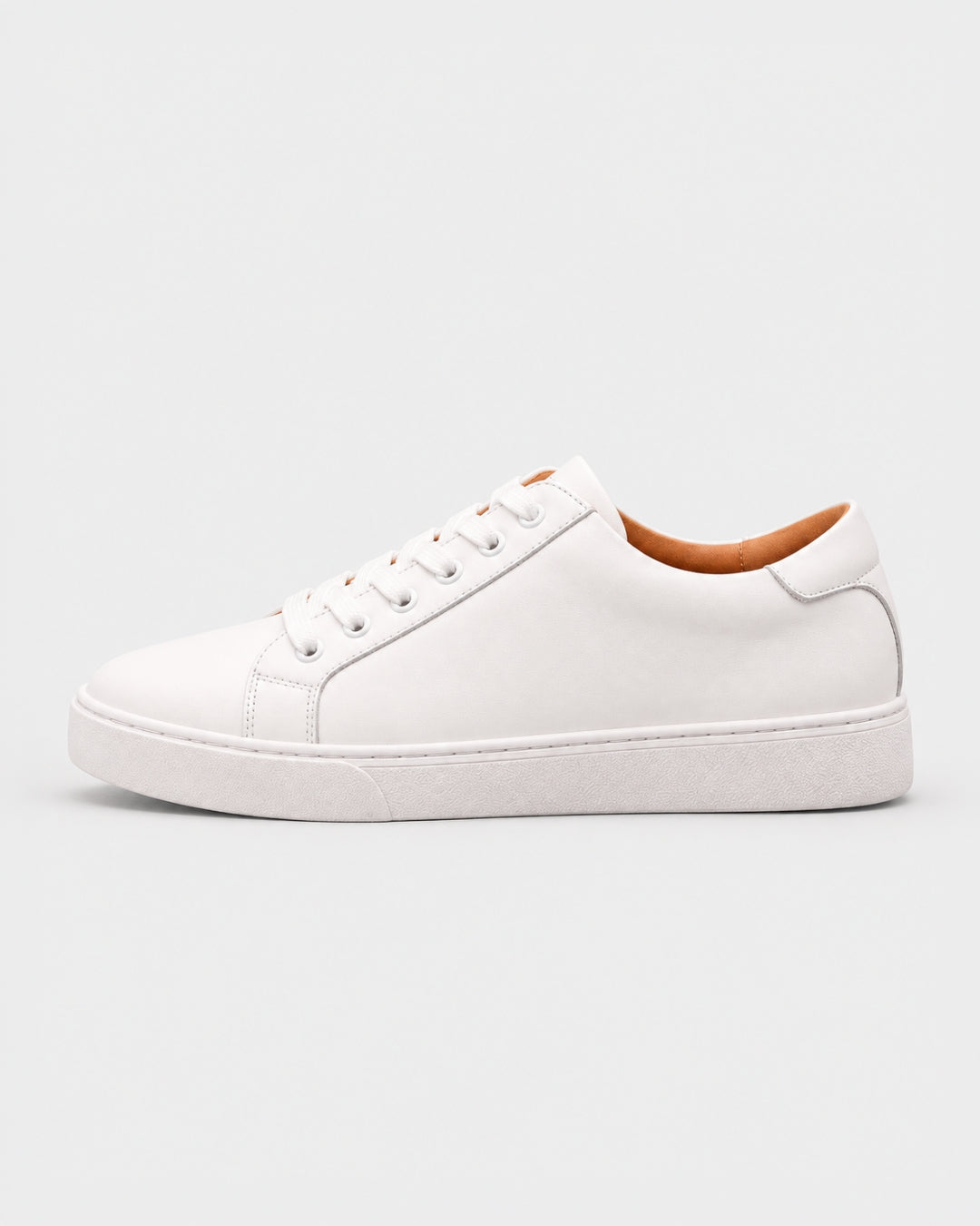 Minimalist white men's low-top dress sneaker in genuine leather with a durable rubber outsole and lace-up design.