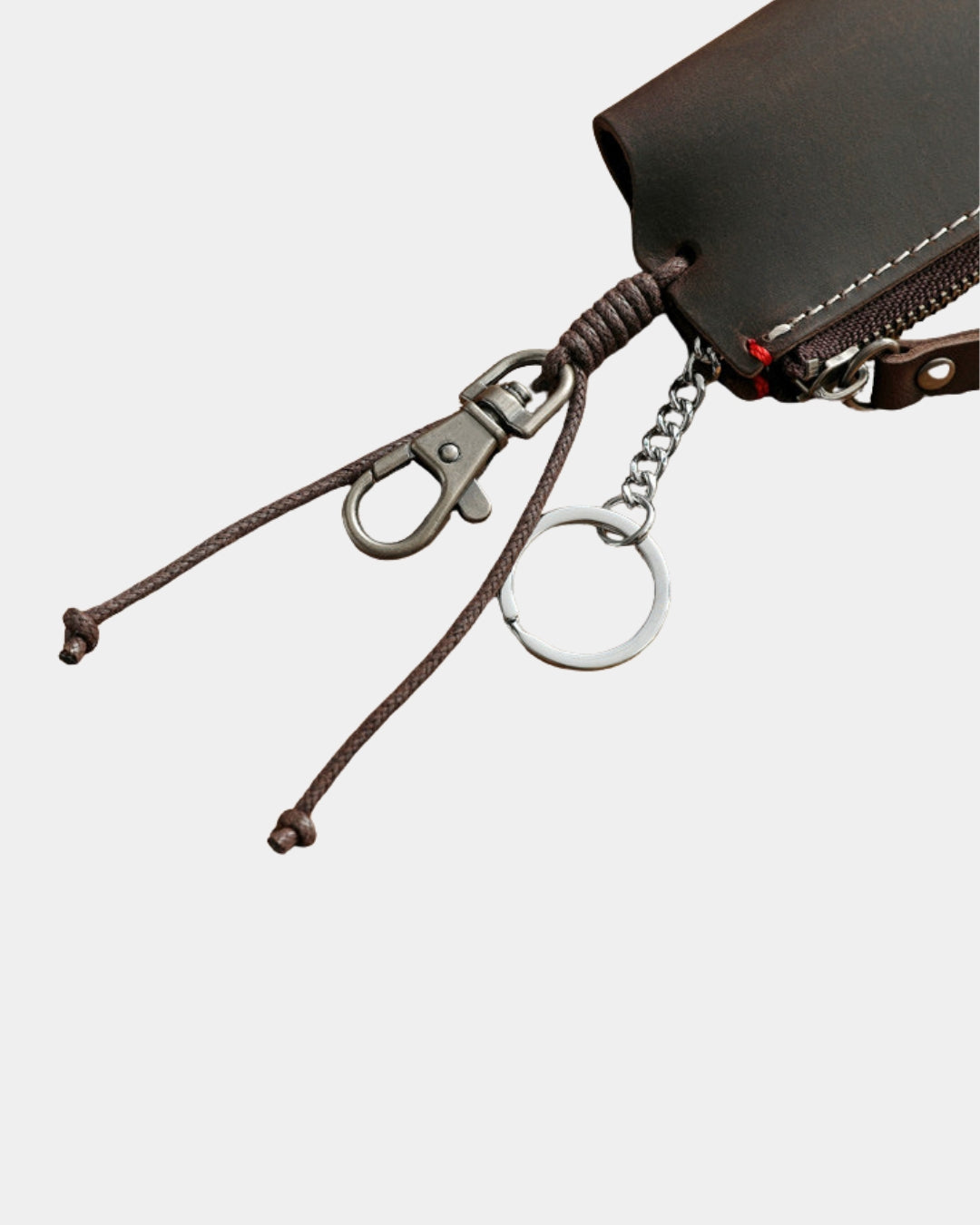 Compact brown genuine leather key wallet with a metal clip, key ring, and zippered compartment.