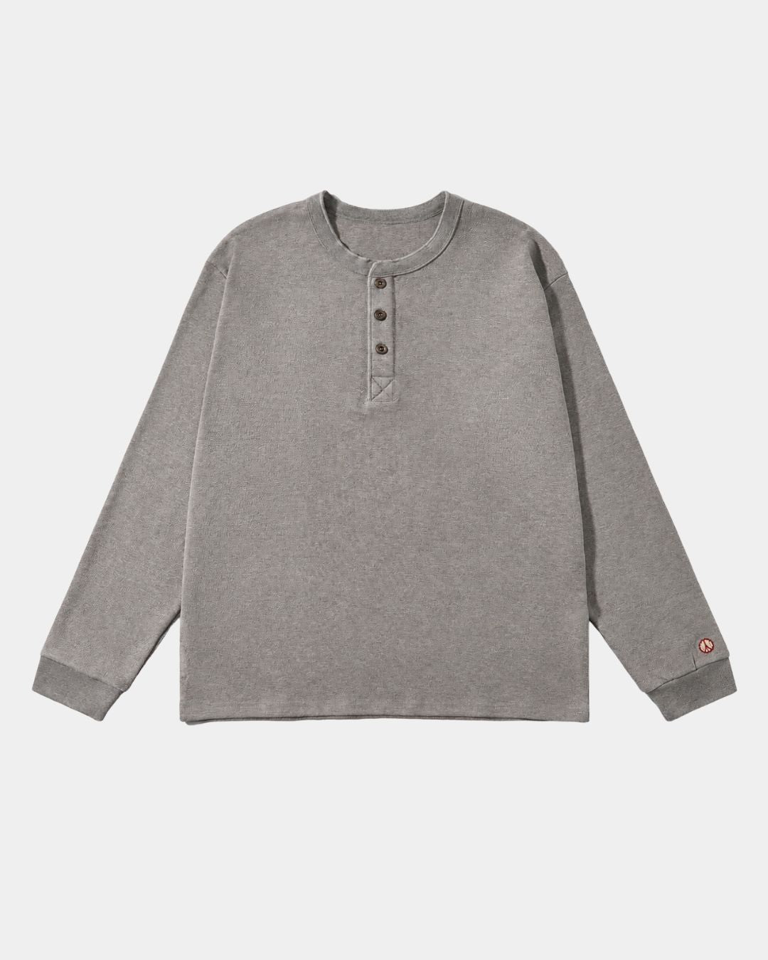 Gray heavyweight cotton long-sleeve henley shirt with a three-button placket, ribbed cuffs, and a small red peace symbol.
