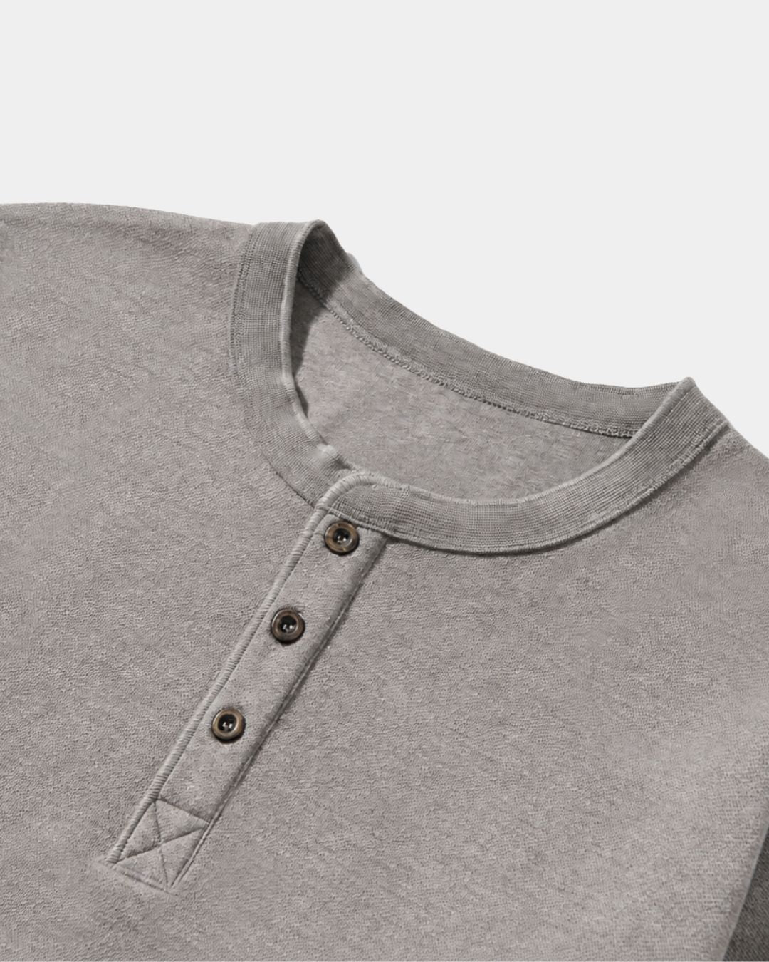 Gray heavyweight cotton henley shirt featuring a three-button placket, ribbed crew neckline, and reinforced X-stitching.