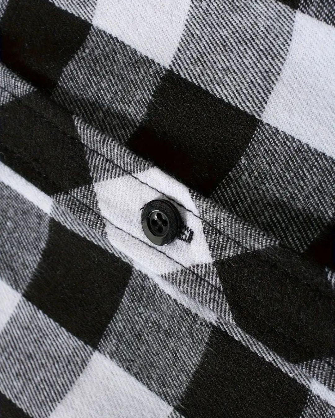 Close-up of a soft, black and white plaid flannel shirt featuring a button-front design and brushed fabric texture.