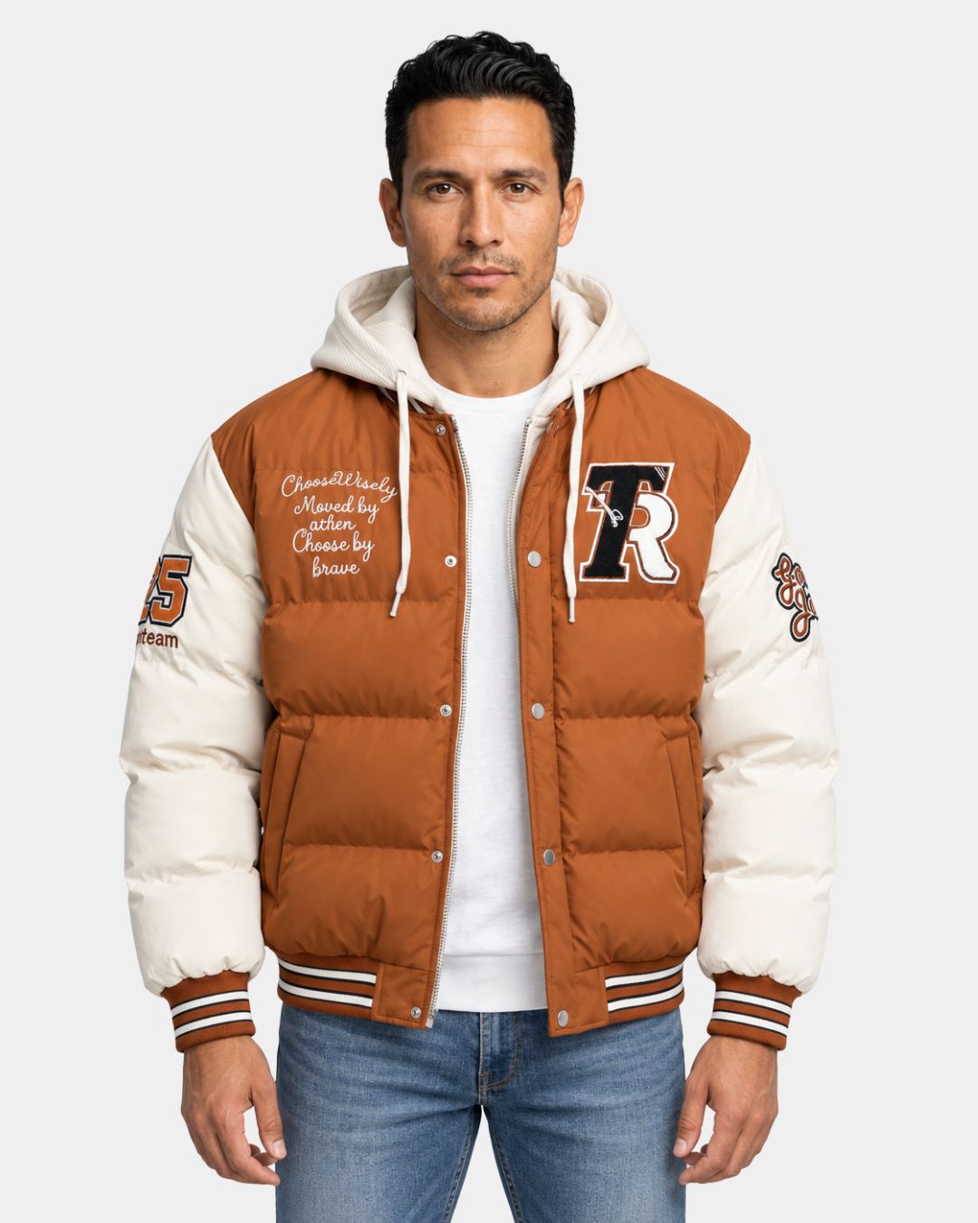 Brown and cream hooded varsity puffer jacket with embroidered patches, zip front, and striped ribbed trim.
